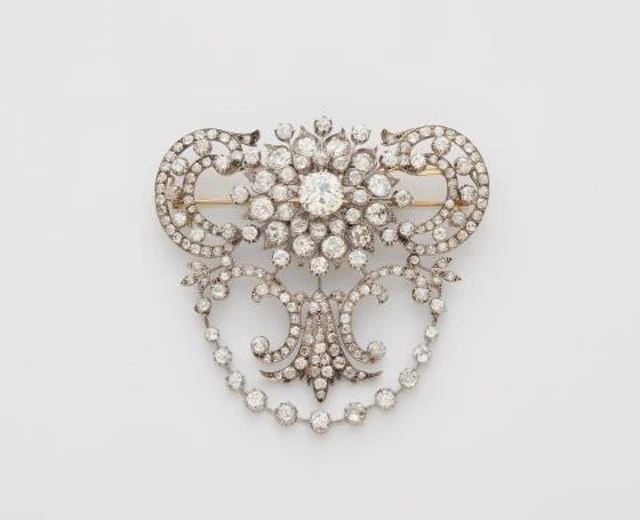 An important silver 14k gold and diamond Belle Epoque stomaker brooch.