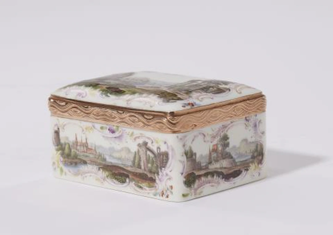 A porcelain snuff box with landscape motifs