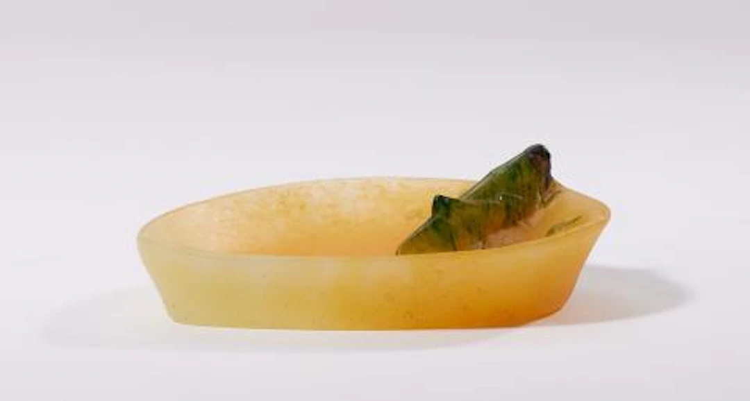 A pâte de verre glass dish with a grasshopper motif