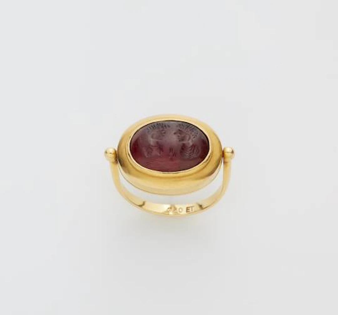 A German 18k gold swivel ring with an ancient Sassanian garnet cabochon