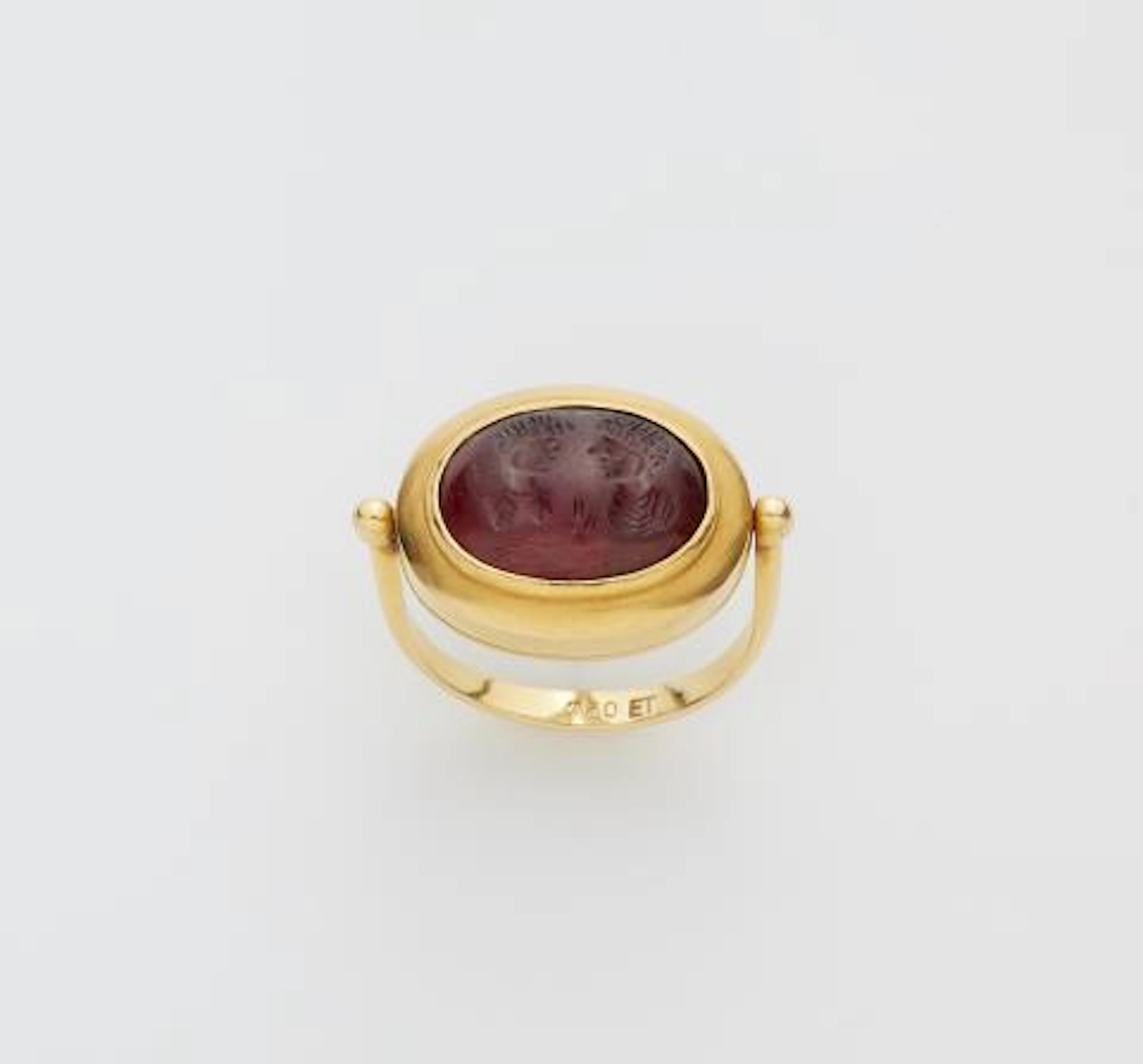 A German 18k gold swivel ring with an ancient Sassanian garnet cabochon