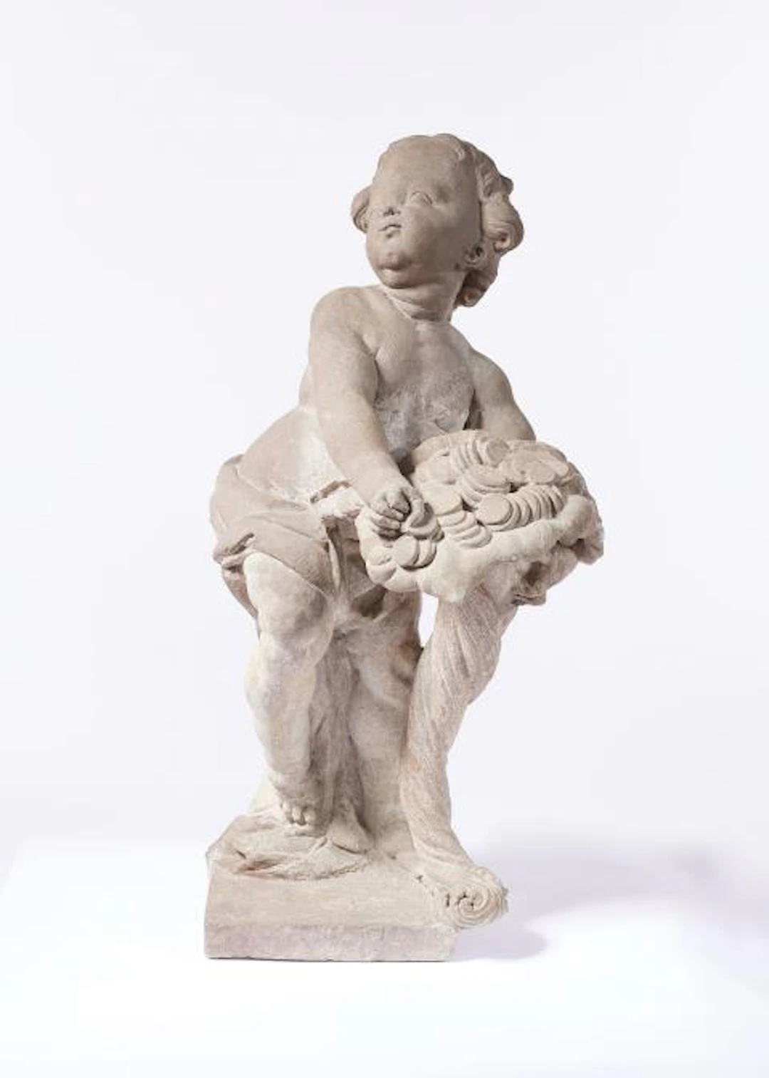 A Dresden sandstone sculpture of Putto as the embodiment of Abundantia