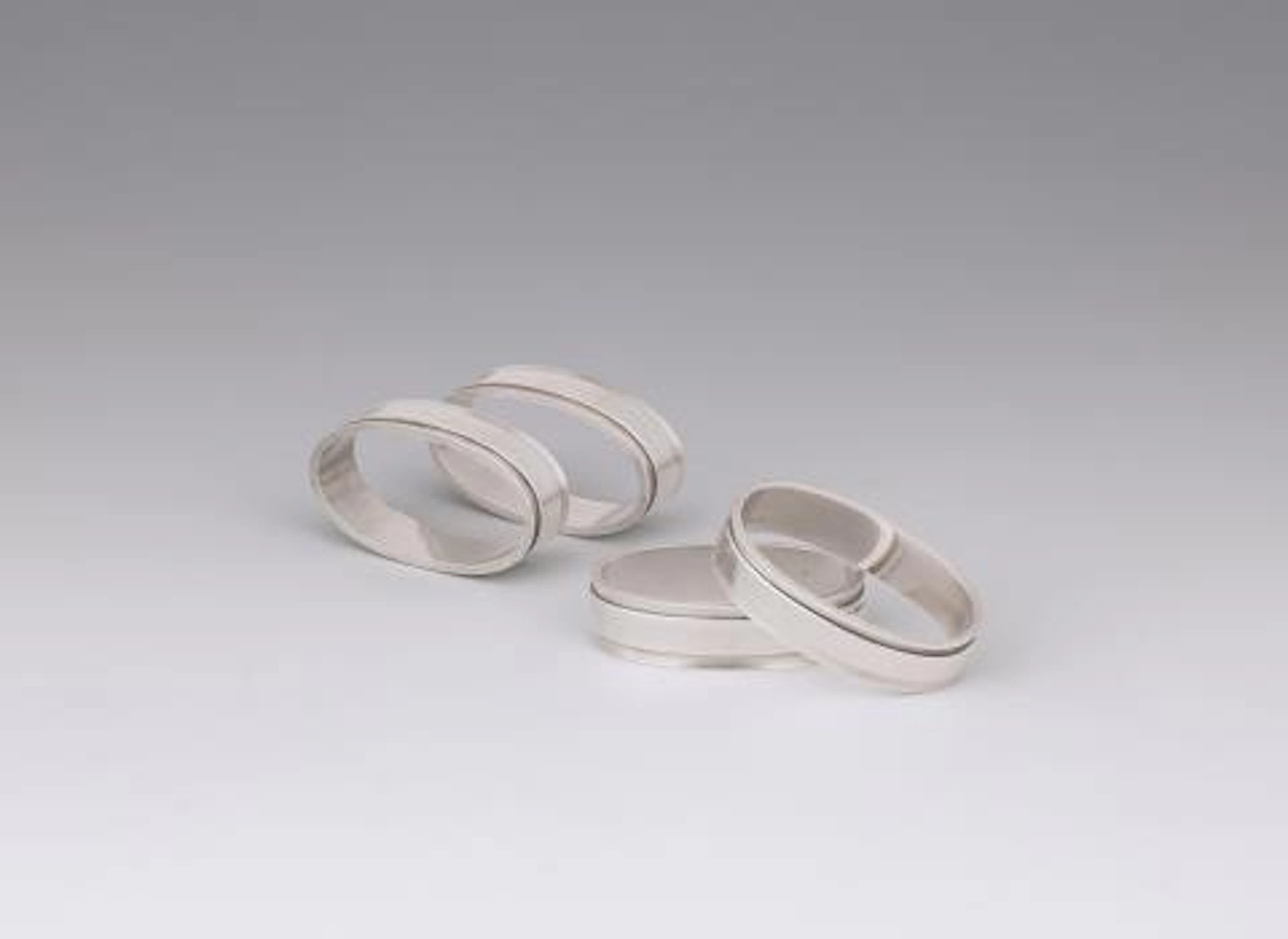 Four Georg Jensen silver napkin rings No 22 A