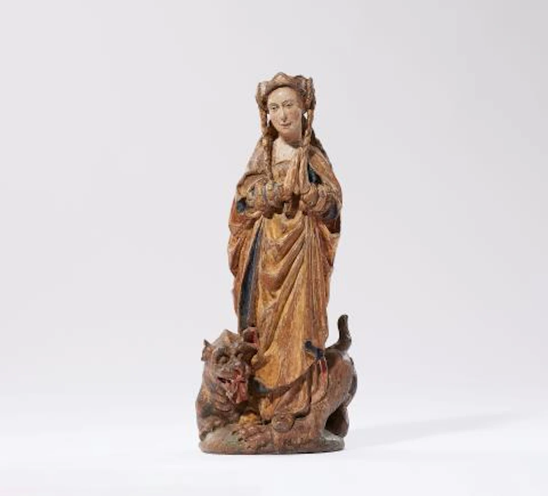 A carved oak figure of St. Margaret of Antioch