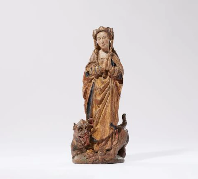 A carved oak figure of St. Margaret of Antioch