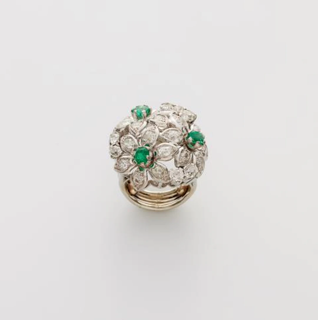 A 14k white gold diamond and emerald giardinetto ring.