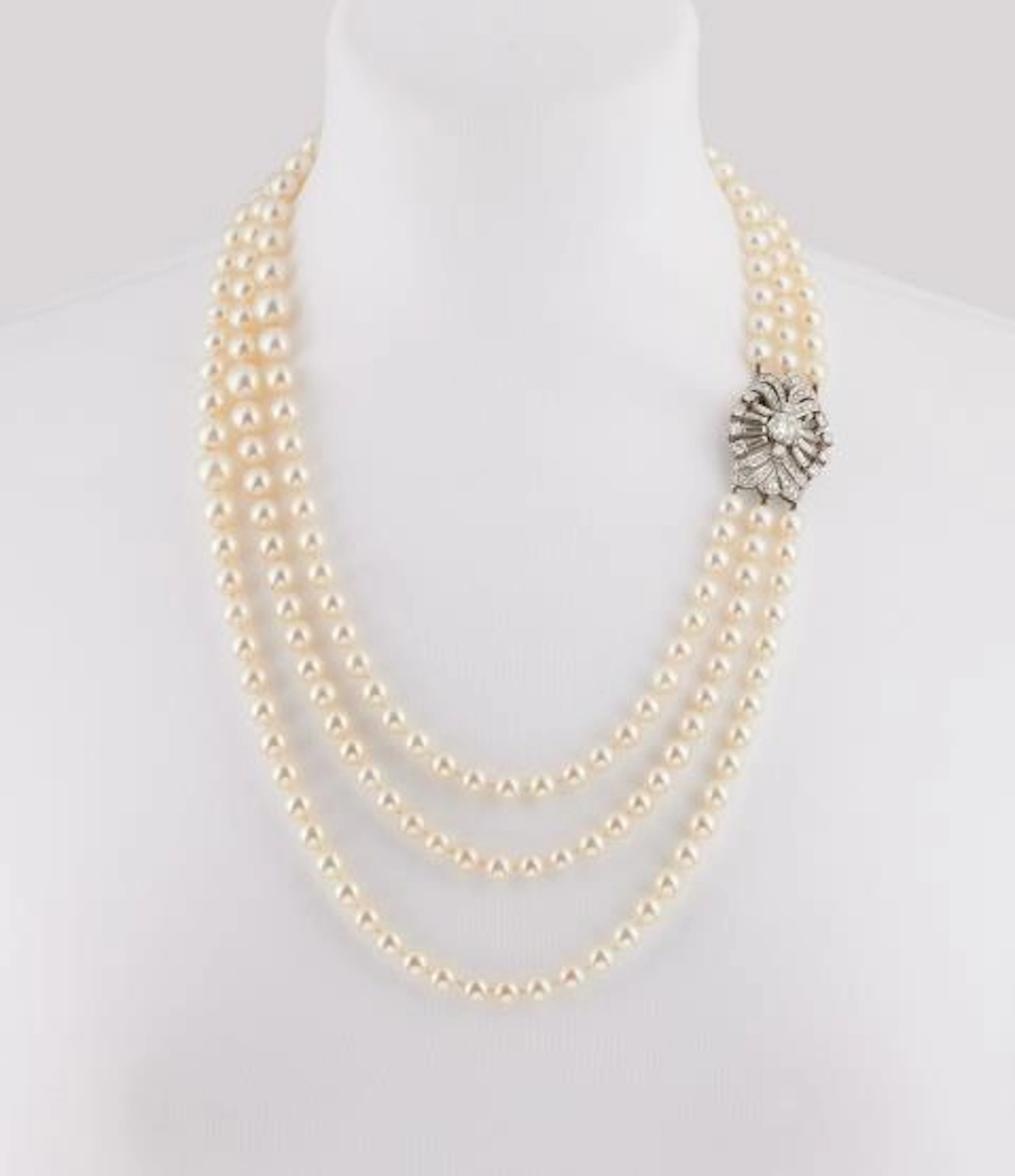 A three row cultured pearl necklace with an 18k white gold and diamond