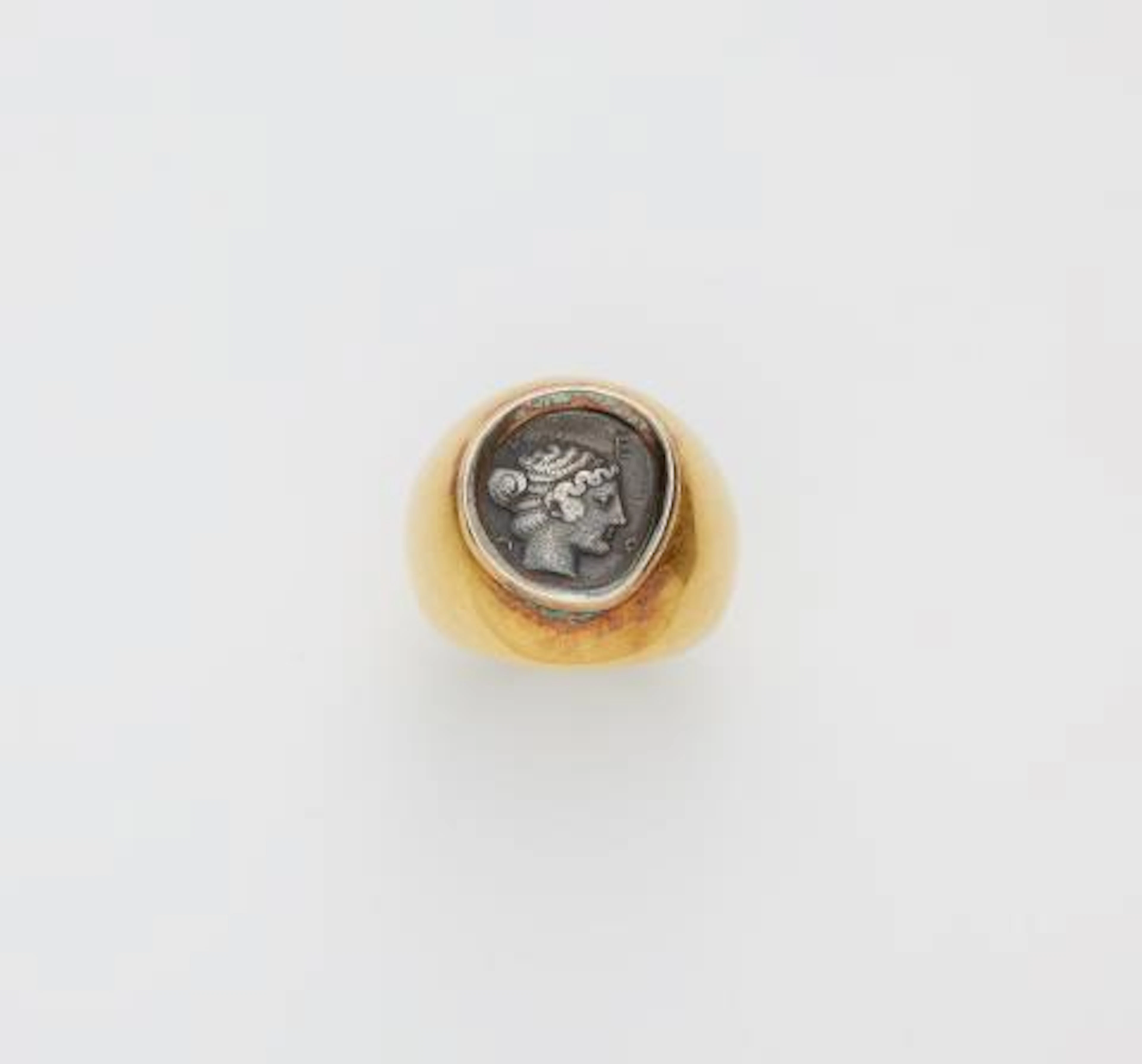 A German chased 18k gold ring with an ancient Hellenistic Triobol
