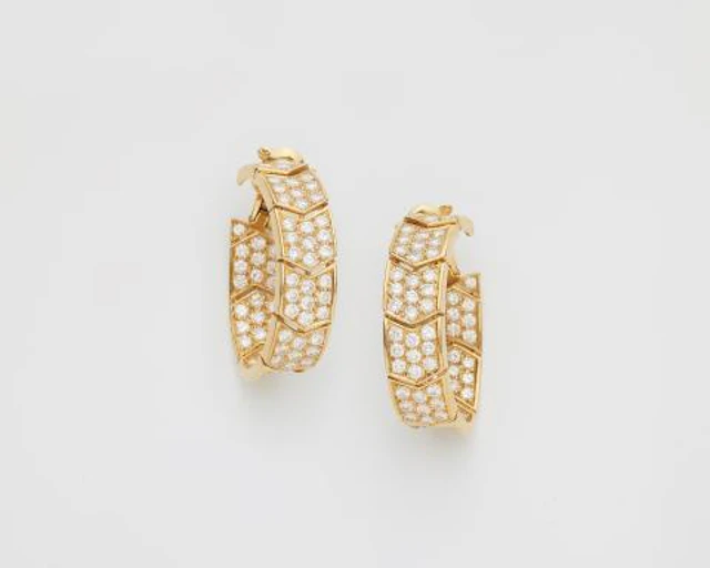 A large pair of French 18k yellow gold and diamond hoop creole clip earrings.