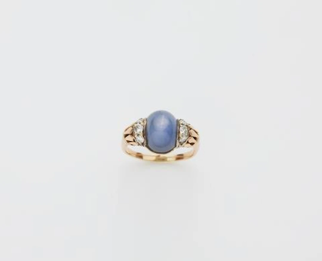A 14k red gold diamond and star sapphire Retro Style ring.