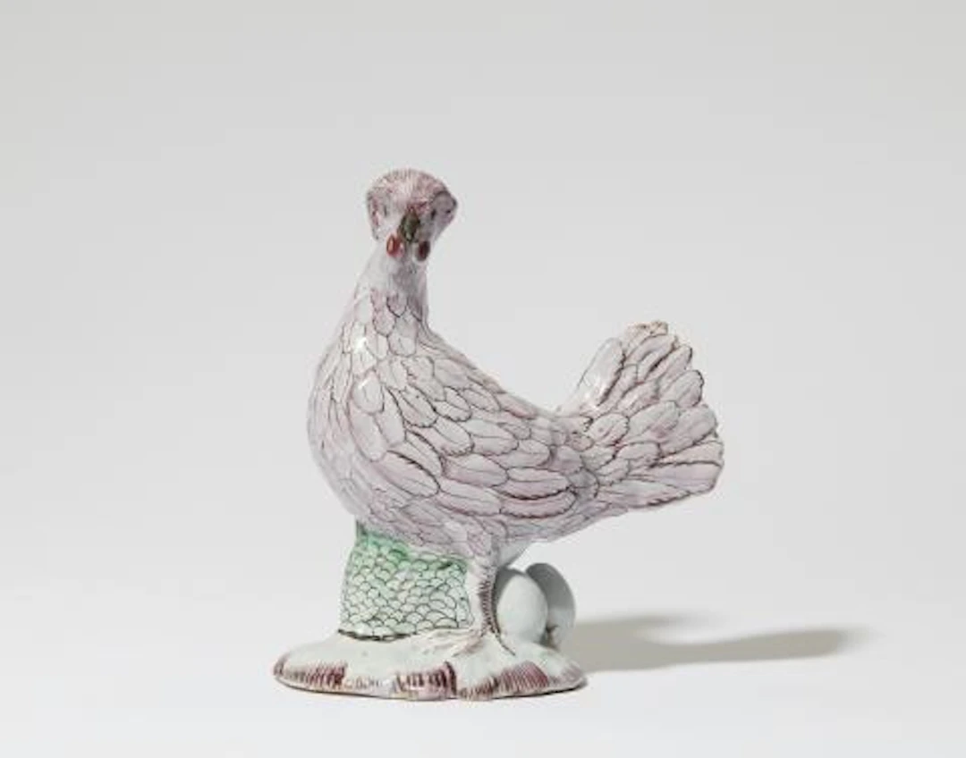 A Polish faience figure of a brooding chicken