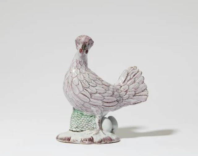 A Polish faience figure of a brooding chicken