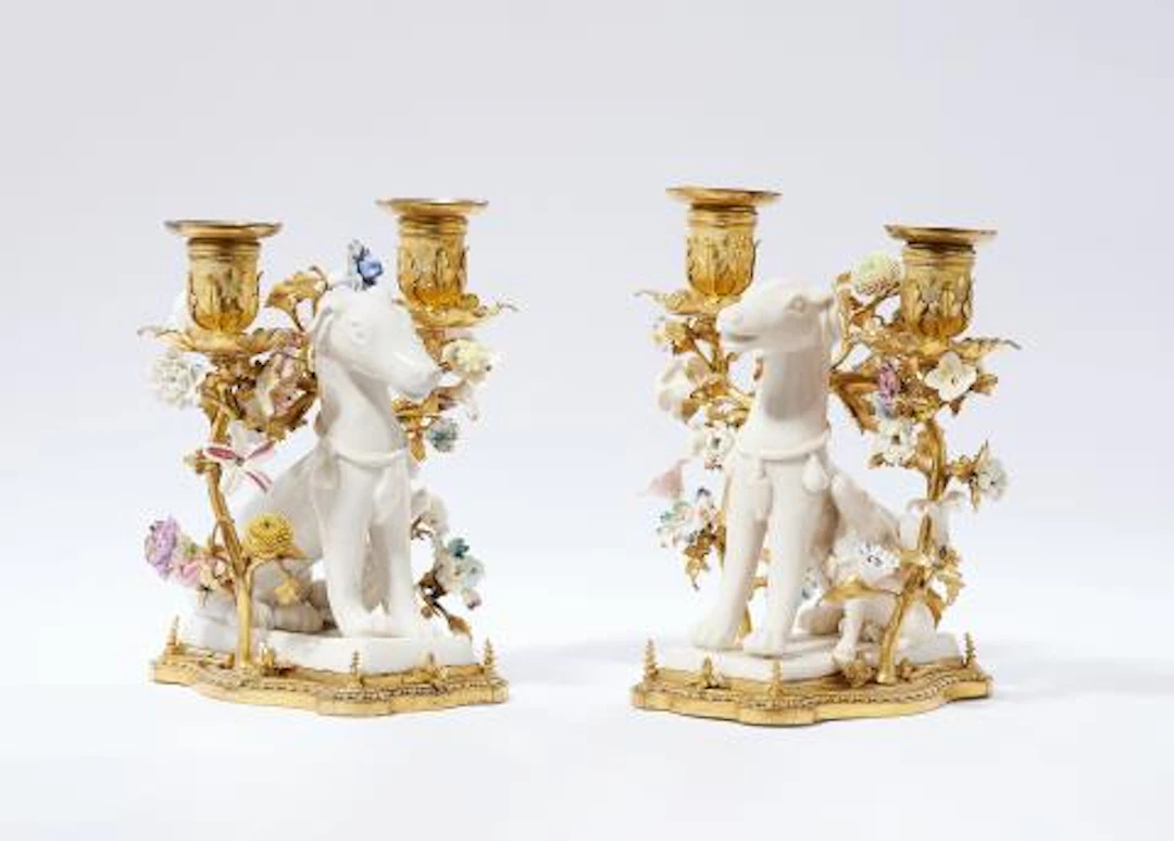 A pair of ormolu candlesticks with sitting dogs