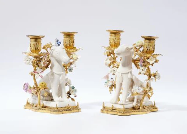 A pair of ormolu candlesticks with sitting dogs