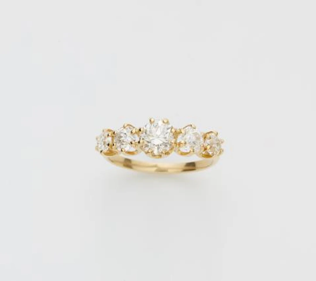 An 18k yellow gold and brilliant-cut diamond five stone ring.