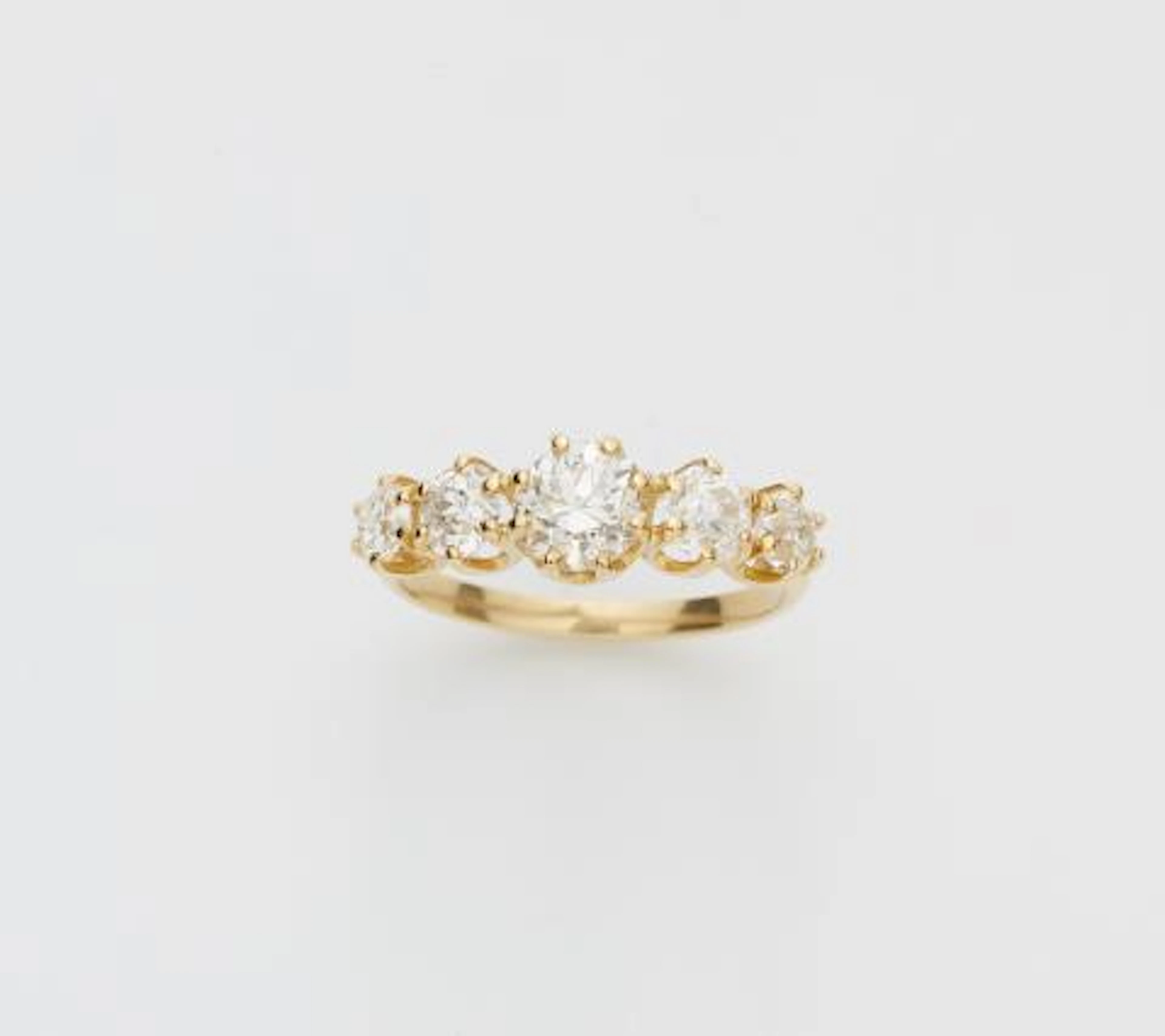 An 18k yellow gold and brilliant-cut diamond five stone ring.