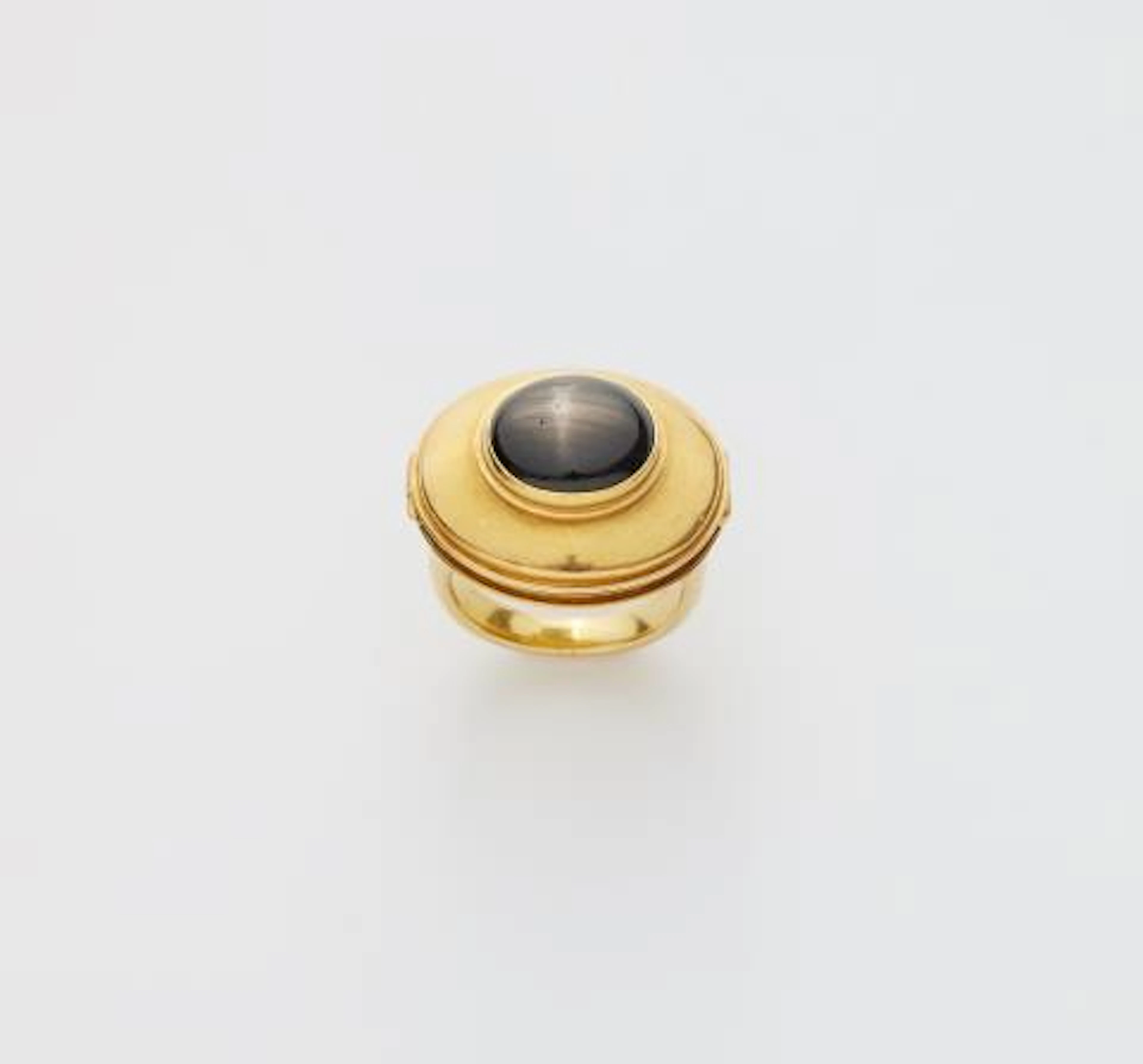 A German 18k gold and black sapphire cabochon friendship snap ring