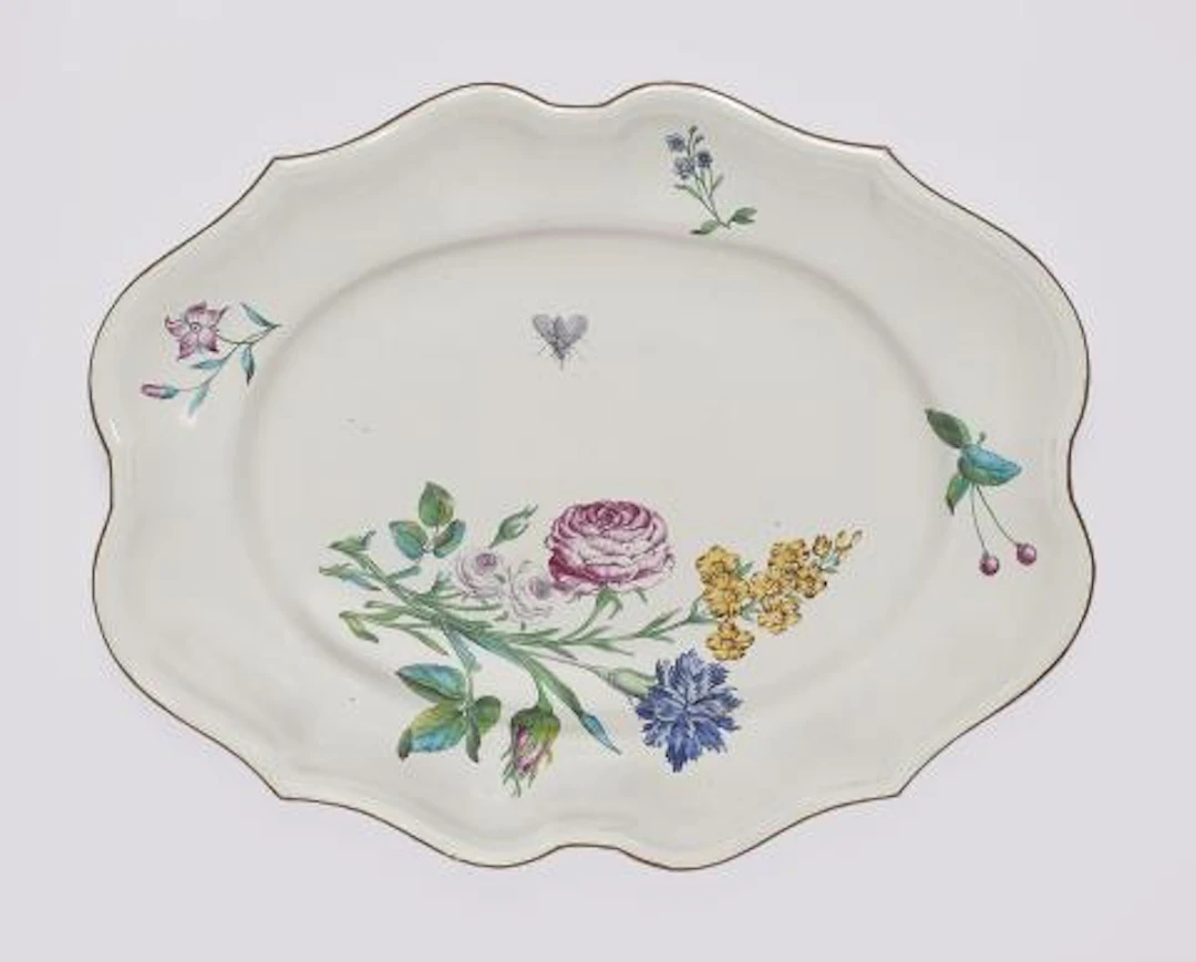 An oval Strasbourg faience plate with finely painted flowers