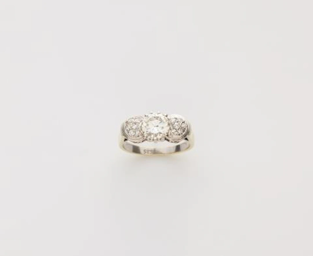 A rhodinated 14k yellow gold and diamond ring.