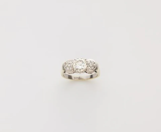 A rhodinated 14k yellow gold and diamond ring.