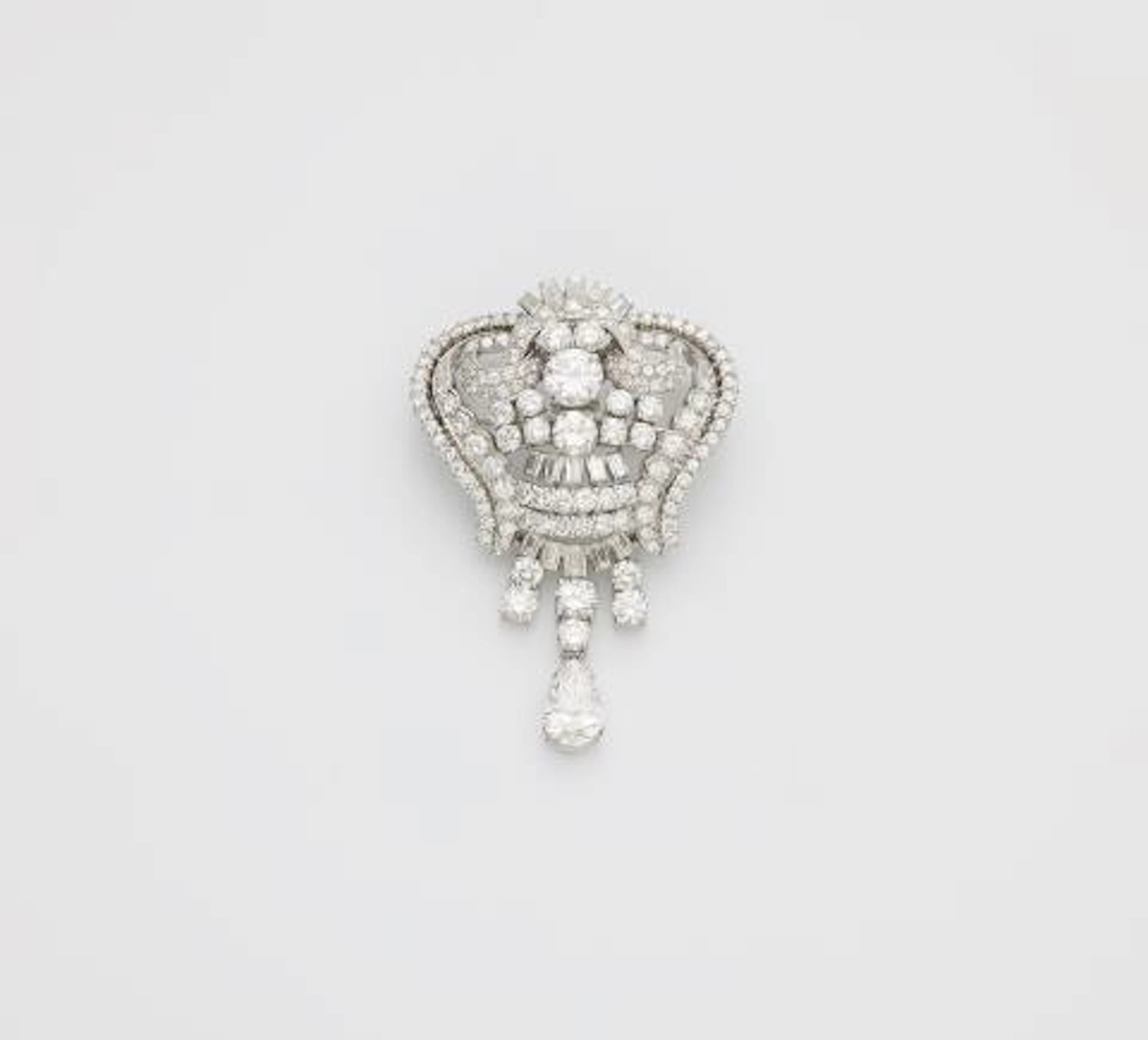 An opulent platinum and diamond cocktail brooch with pendilia.