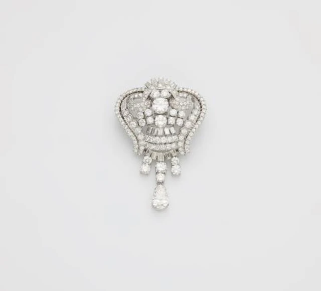 An opulent platinum and diamond cocktail brooch with pendilia.