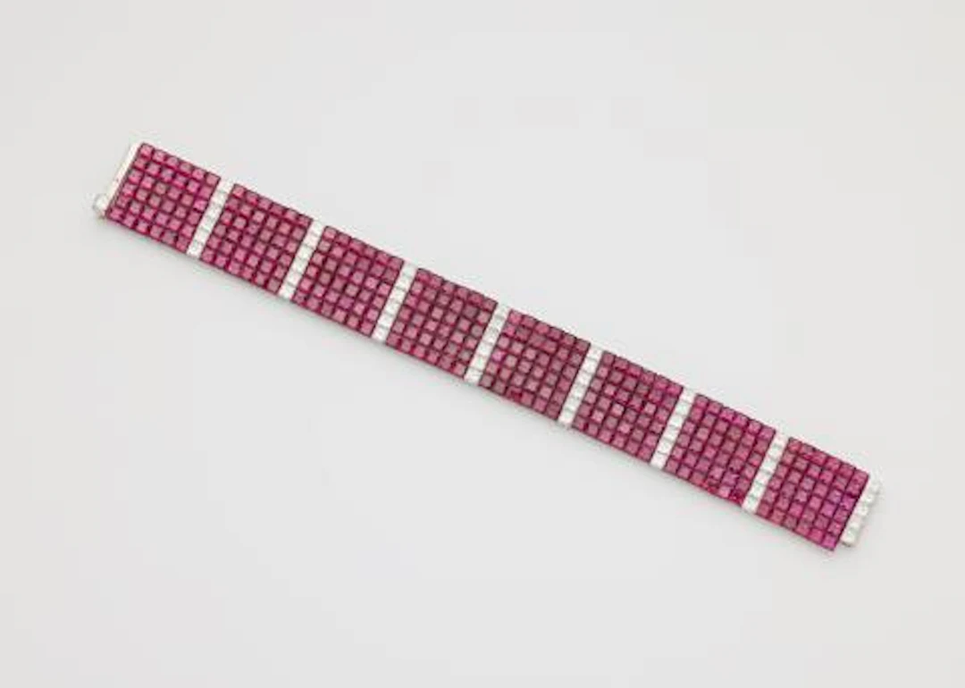 A platinum diamond and invisible-set ruby flexible bracelet.