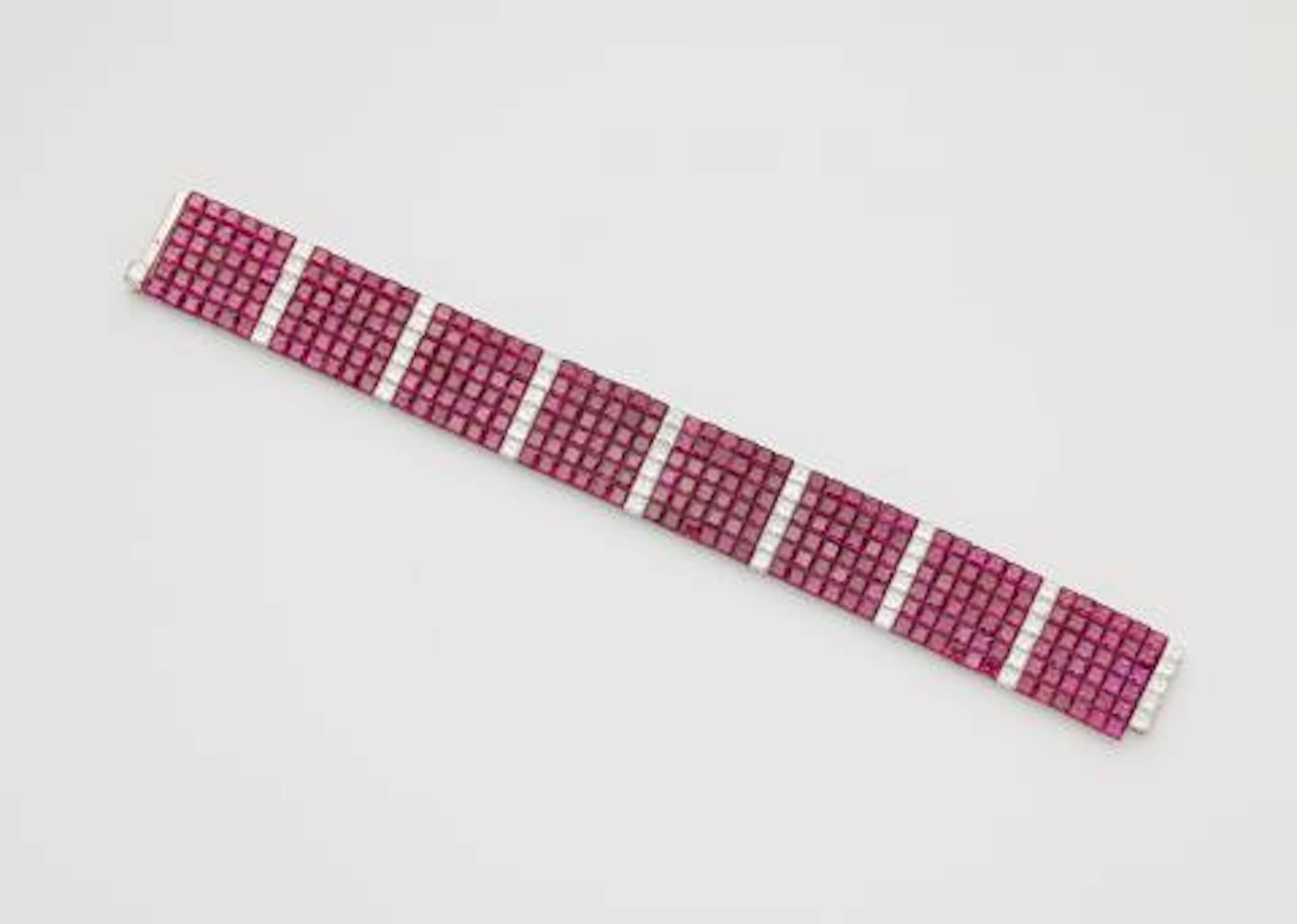 A platinum diamond and invisible-set ruby flexible bracelet.
