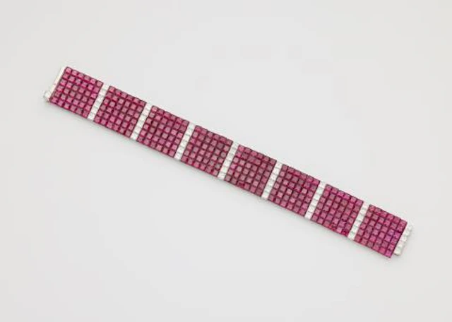 A platinum diamond and invisible-set ruby flexible bracelet.