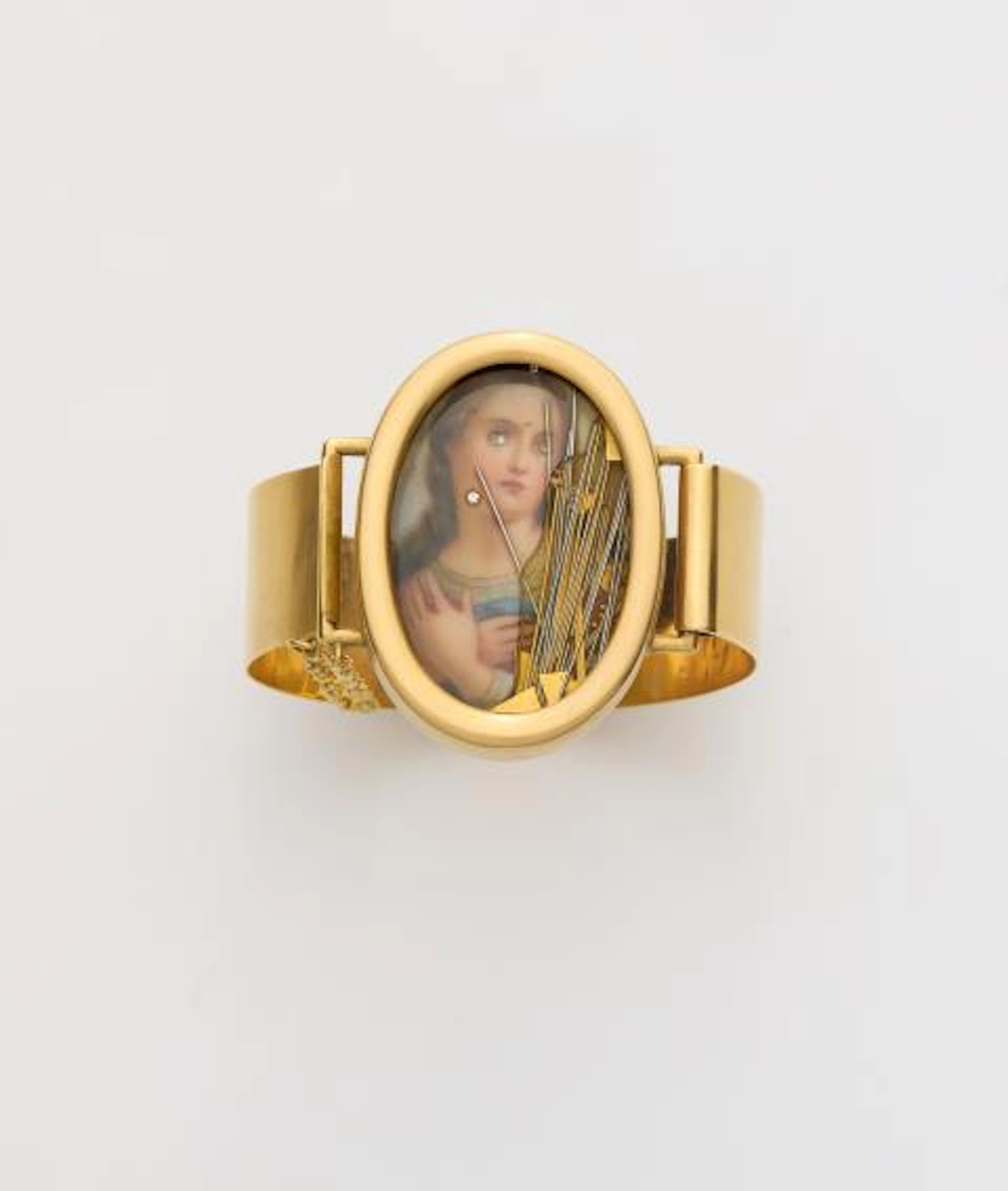 A German 18k yellow gold kinetic capsule bracelet with a religious miniature.