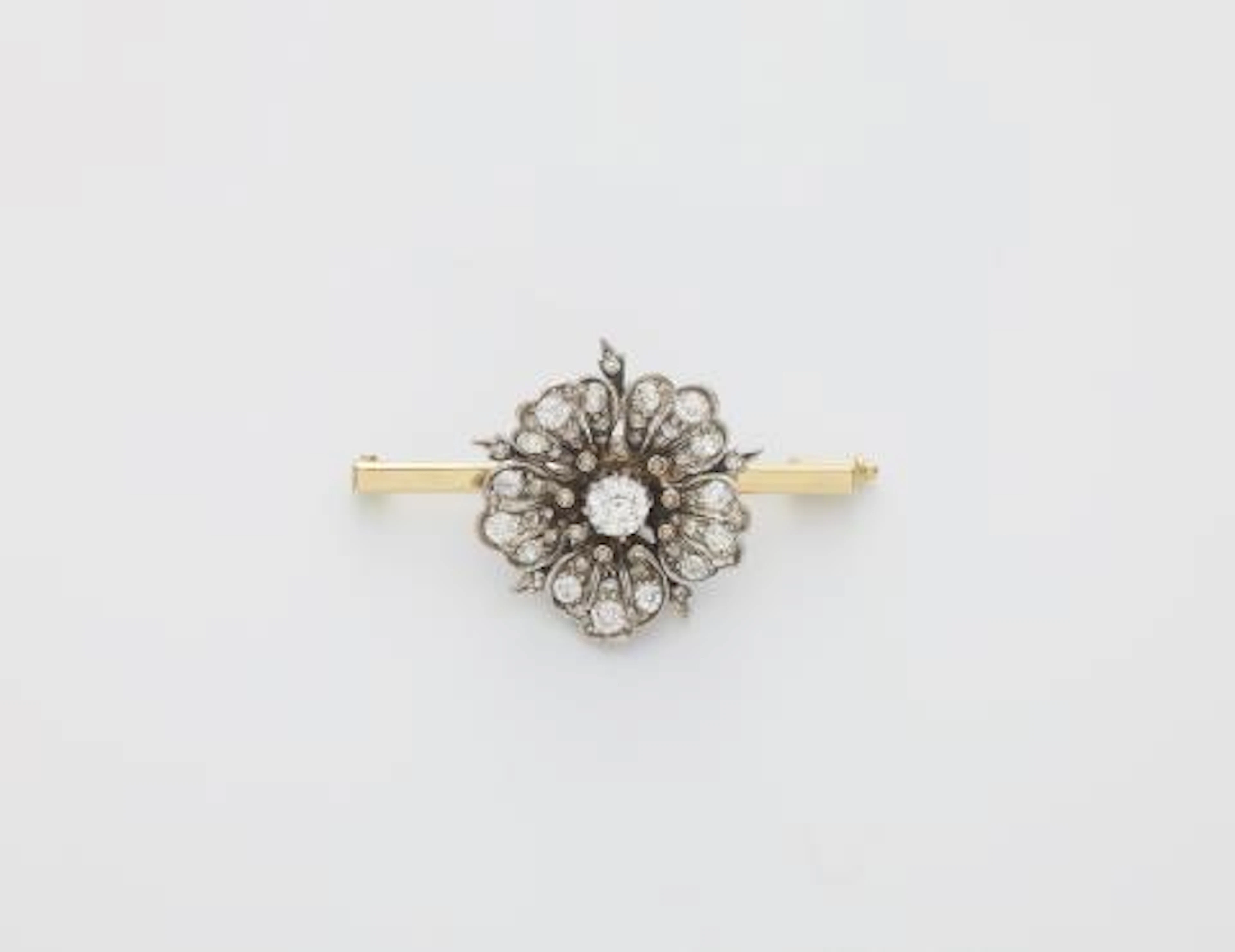 A 14k white gold and diamond wild rose blossom later mounted on a bar brooch.