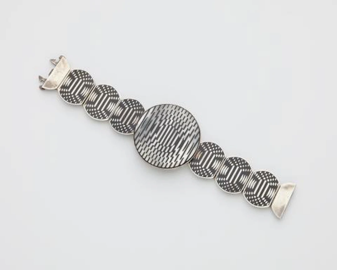 A Sterling silver mother of pearl and black enamel Op Art bracelet.