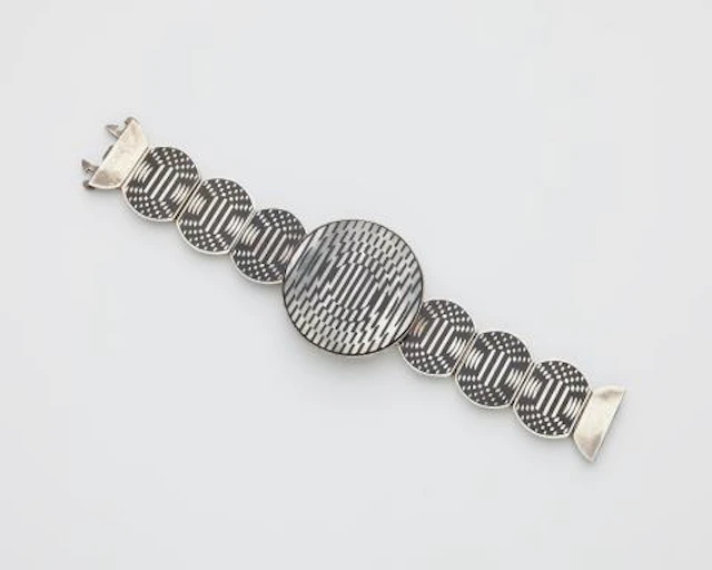 A Sterling silver mother of pearl and black enamel Op Art bracelet.