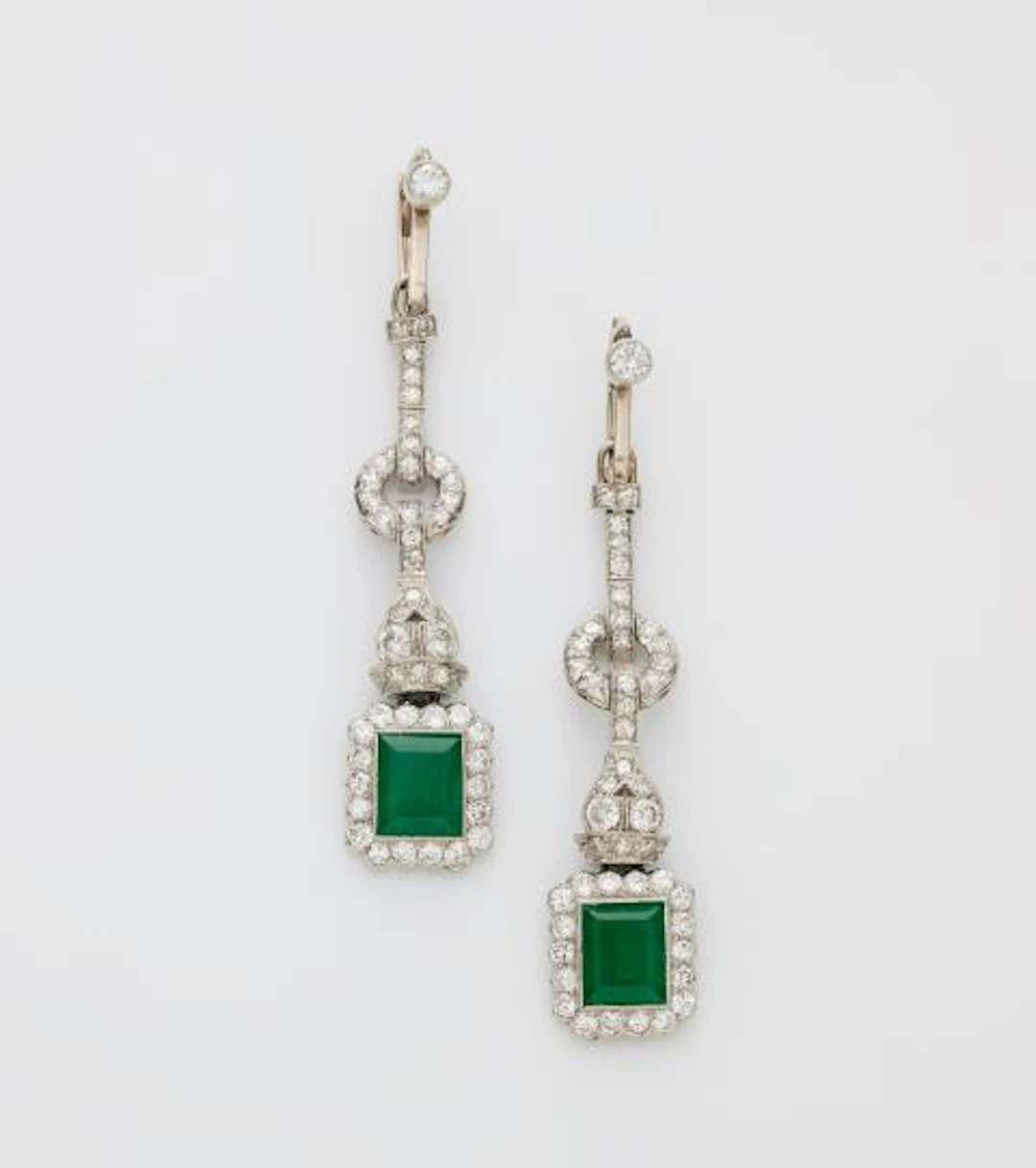 A pair of 14k white gold diamond and emerald Art Déco pendant earrings