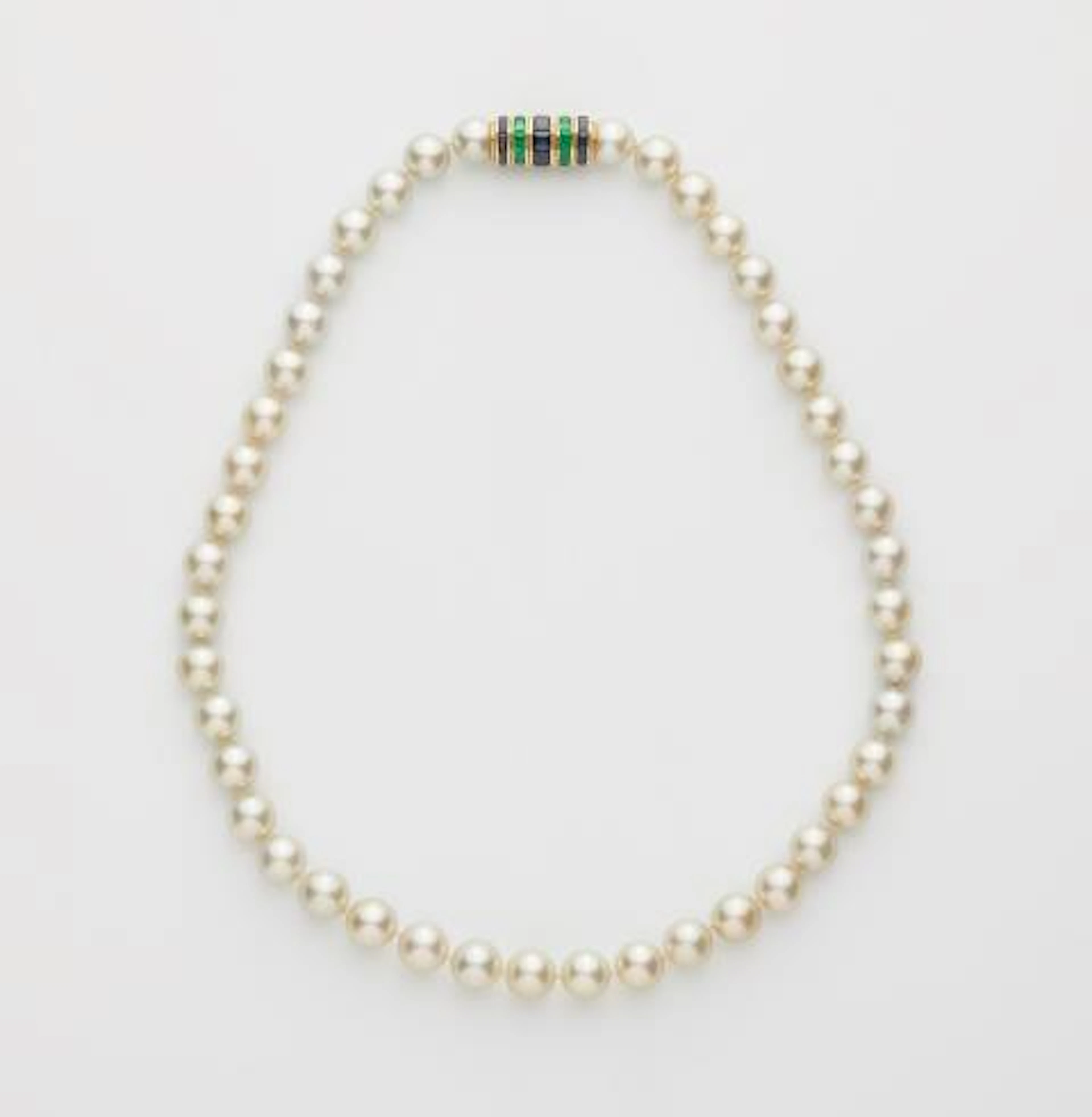 A fine cultured pearl necklace with an 18k yellow gold emerald and