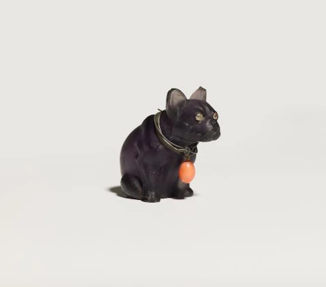A frosted carved amethyst model of a sitting French Bulldog wearing