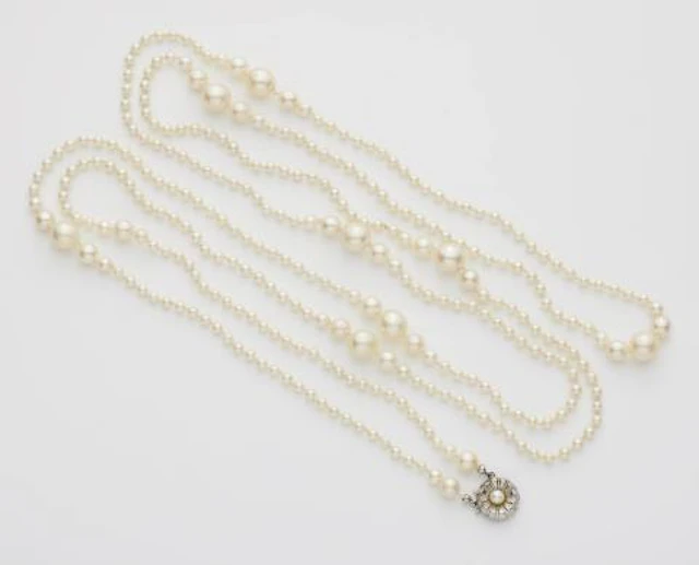 A silver and pearl sautoir.