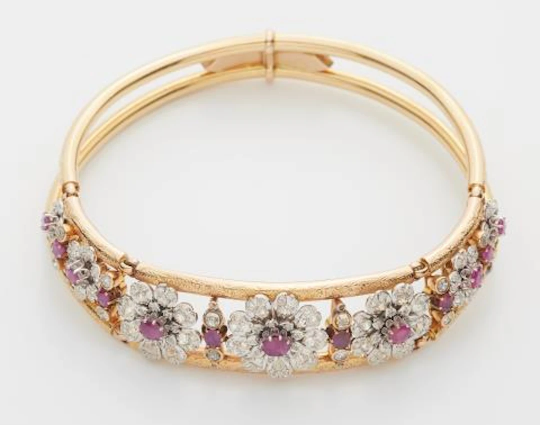 An 18k two colour gold old-cut diamond and ruby Retro Style neck bangle.