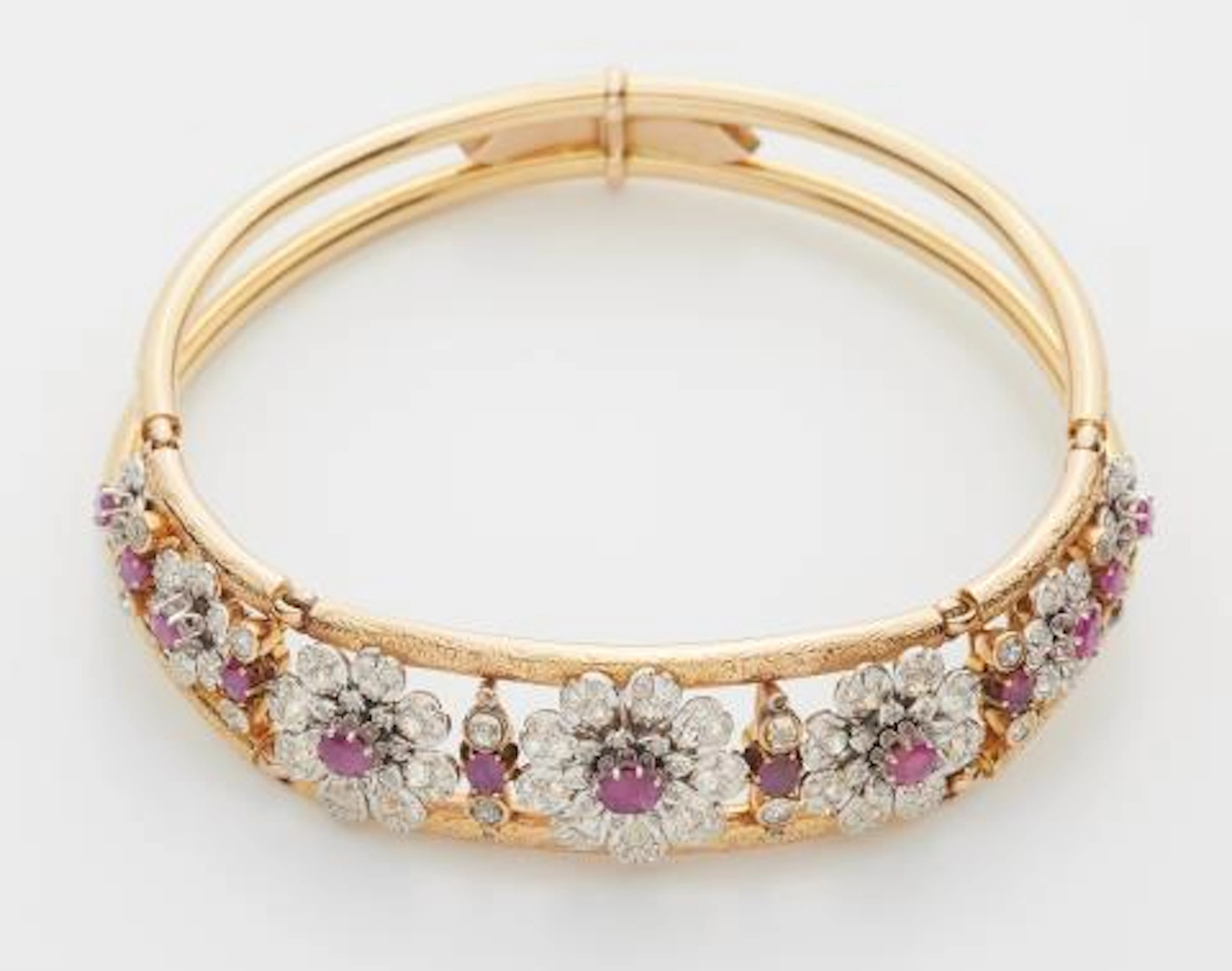 An 18k two colour gold old-cut diamond and ruby Retro Style neck bangle.