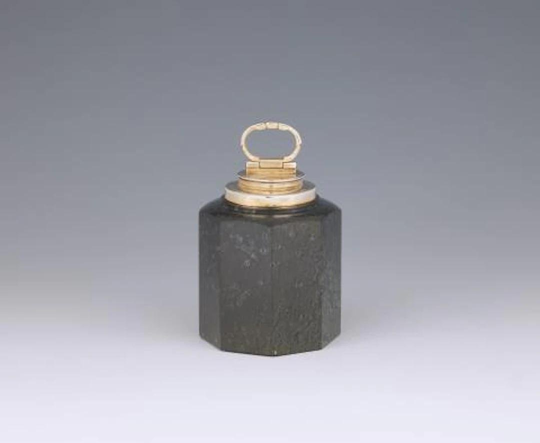 A silver-mounted serpentine canister