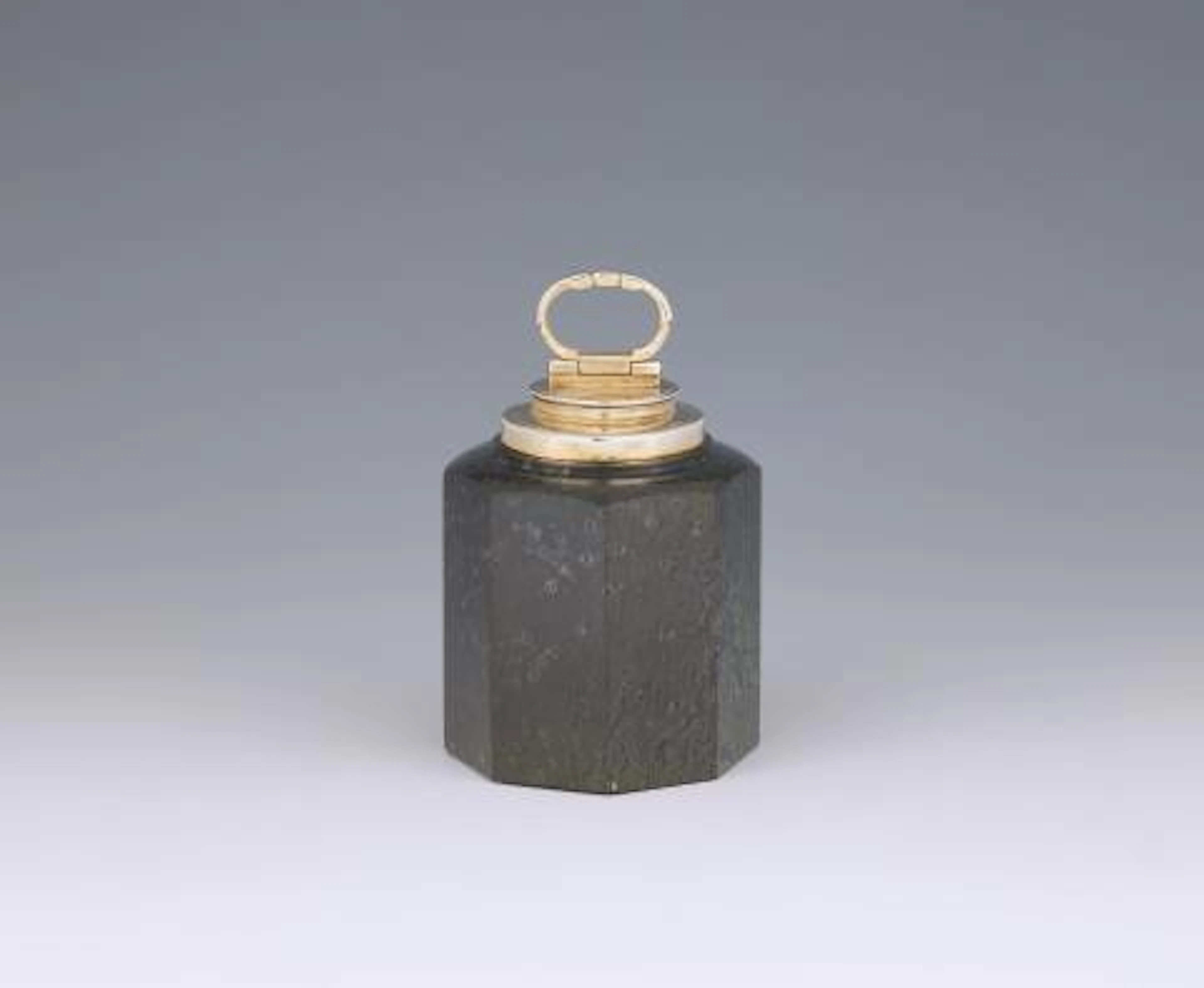 A silver-mounted serpentine canister