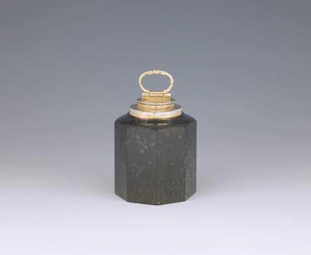 A silver-mounted serpentine canister