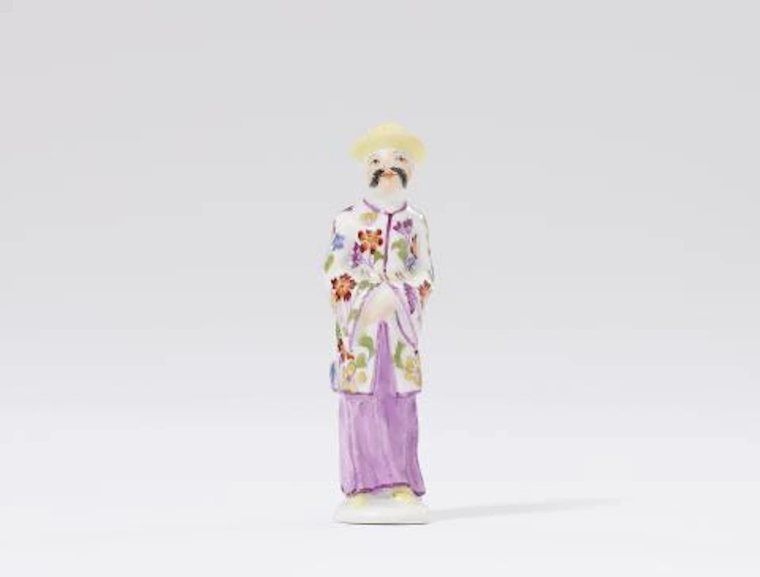 A Meissen porcelain figure of a Chinese man as a pipe tamper