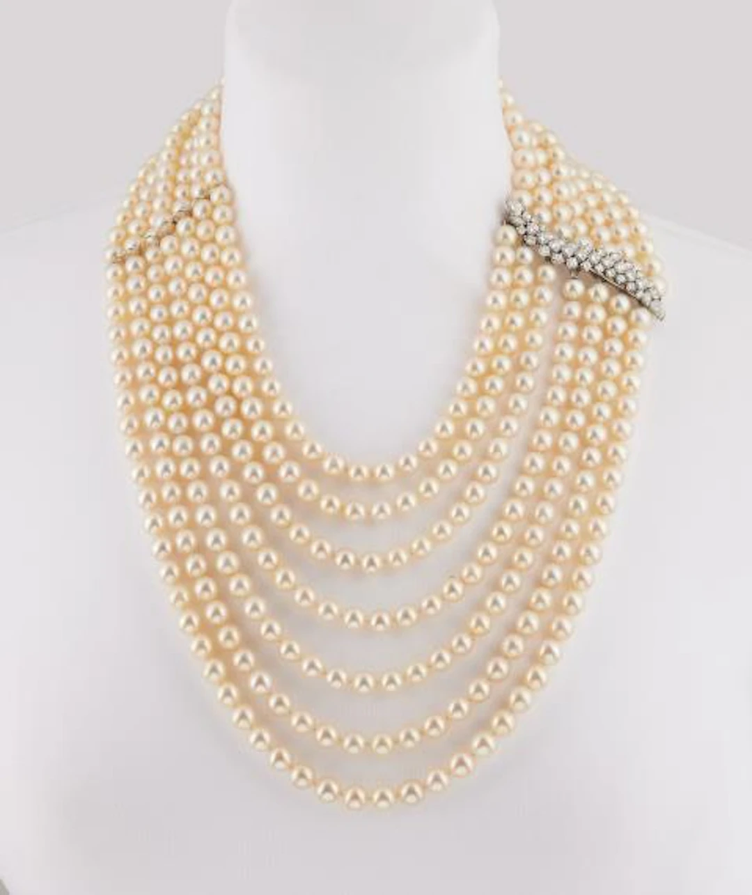 An opulent seven row cultured pearl waterfall necklace with an 18k
