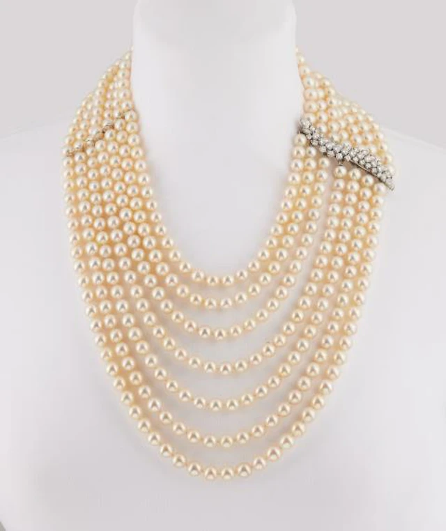 An opulent seven row cultured pearl waterfall necklace with an 18k