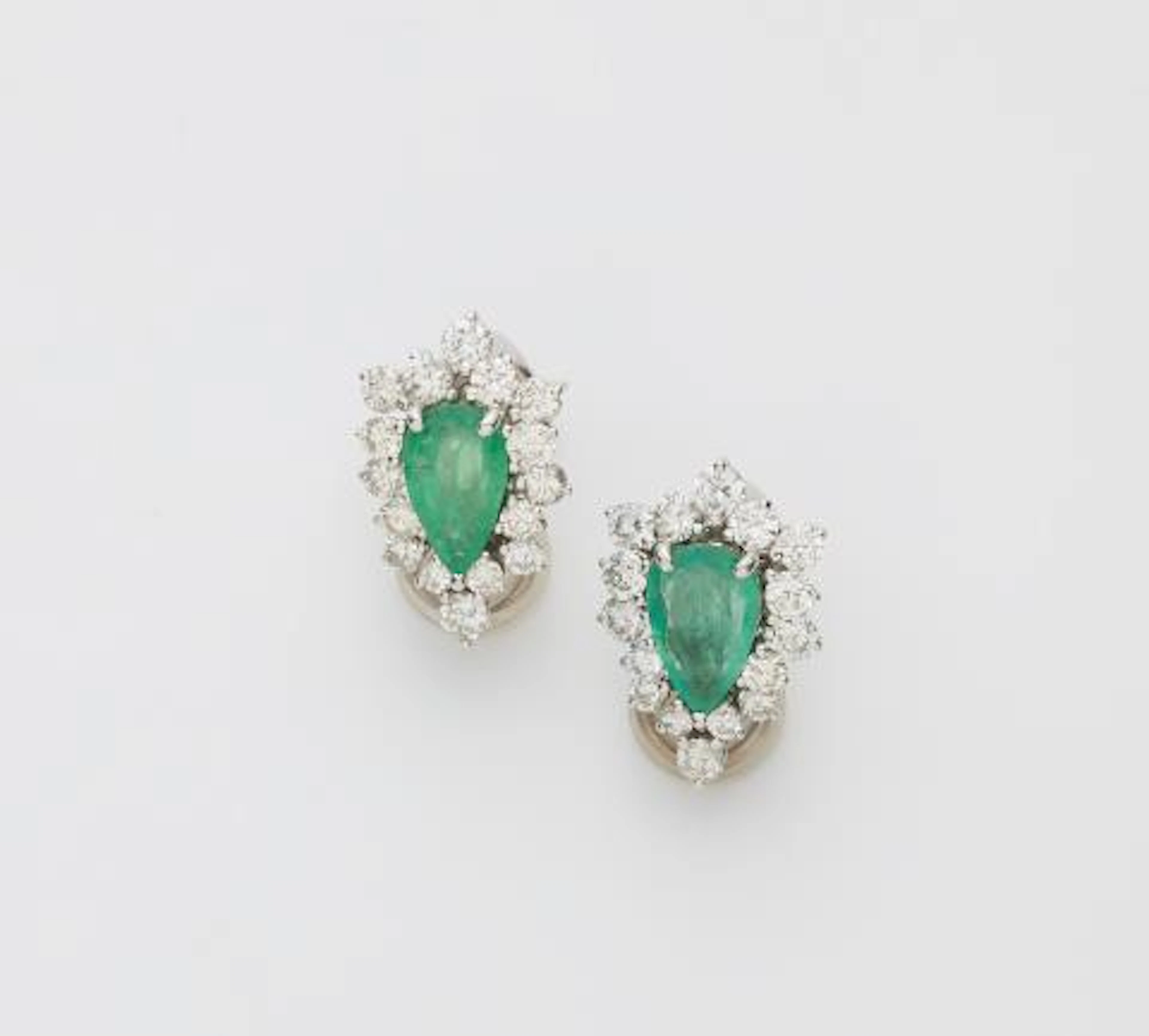 A pair of 18k white gold diamond and pear-cut emerald clip earrings.