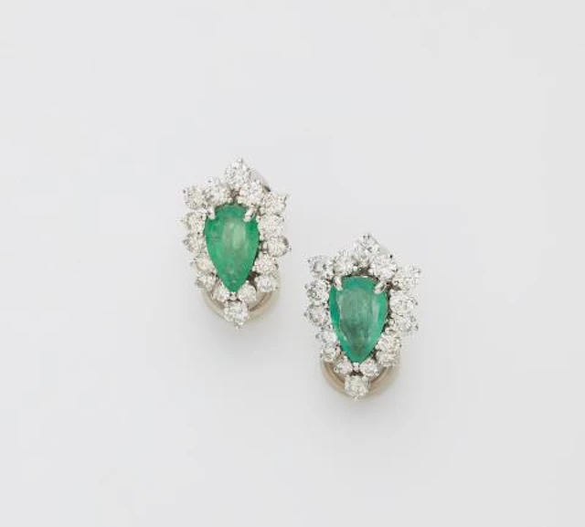A pair of 18k white gold diamond and pear-cut emerald clip earrings.