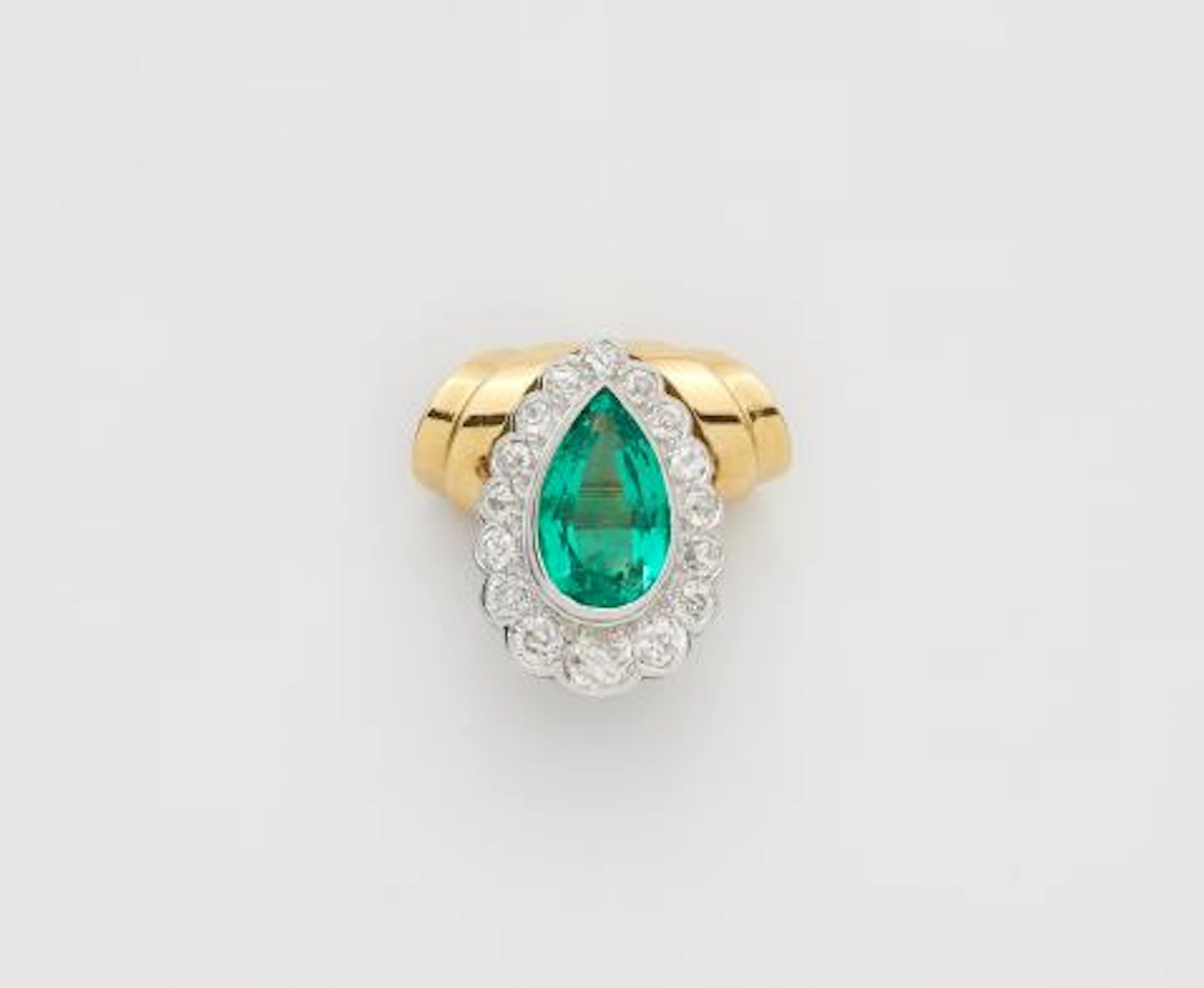 An 18k gold pendant using a platinum diamond and Colombian emerald