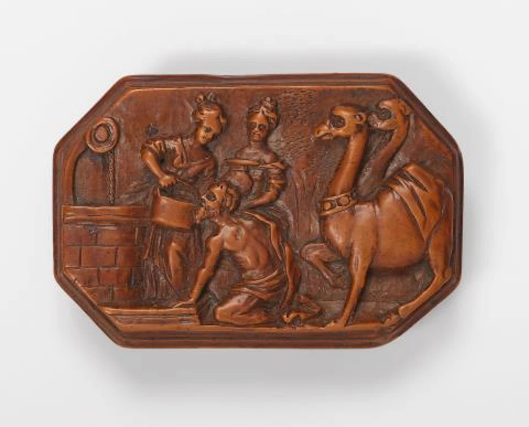 An octagonal boxwood box depicting Rebecca and Jacob at the well