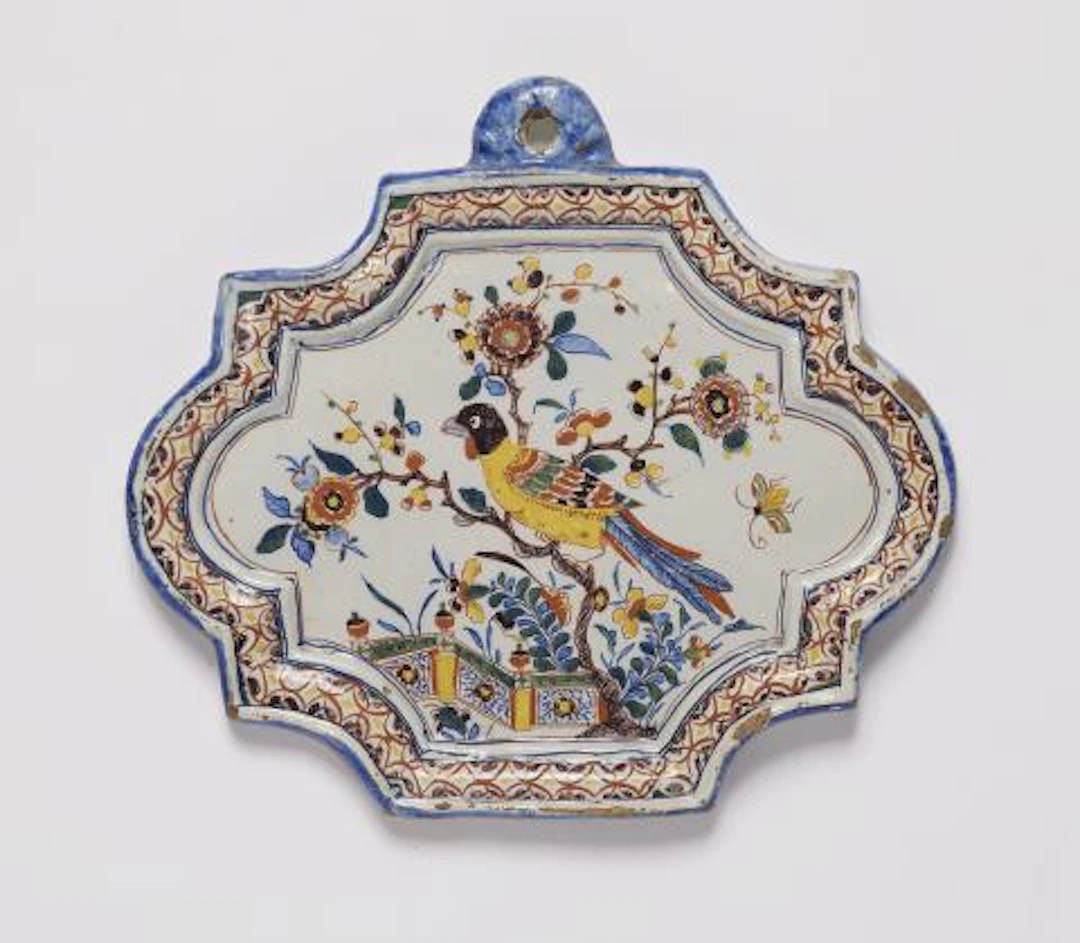 A small Dutch Delft faience plaque with an exotic bird